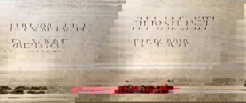 Stone inscribed with "Their Name Liveth for Evermore" with three red poppy wreaths