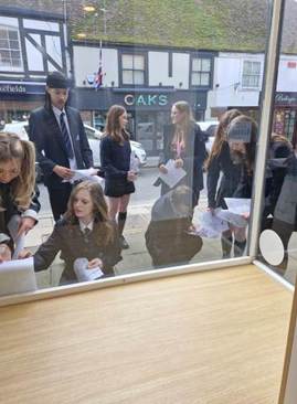 A group of people standing outside a window

AI-generated content may be incorrect.