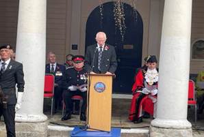 A person standing at a podium with a group of people sitting in front of him

AI-generated content may be incorrect.